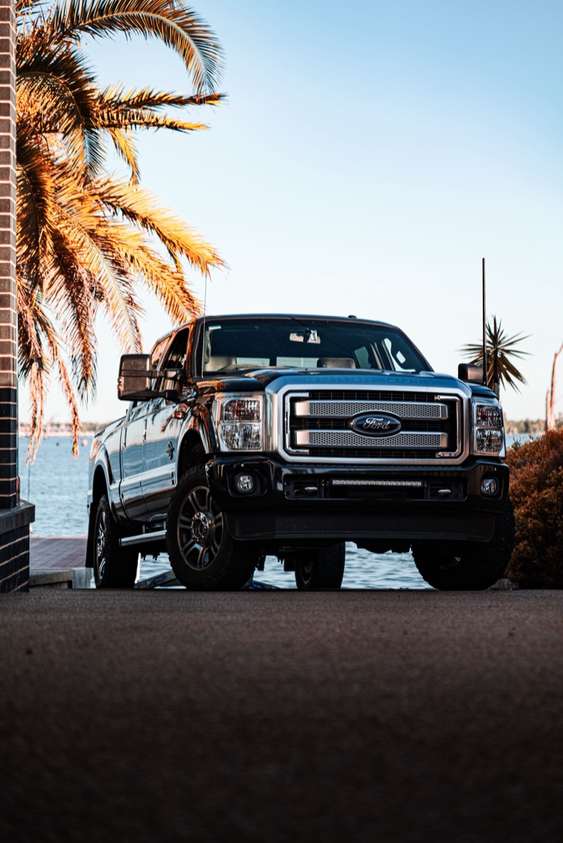 Heavy-duty diesel pickup parked by the water.